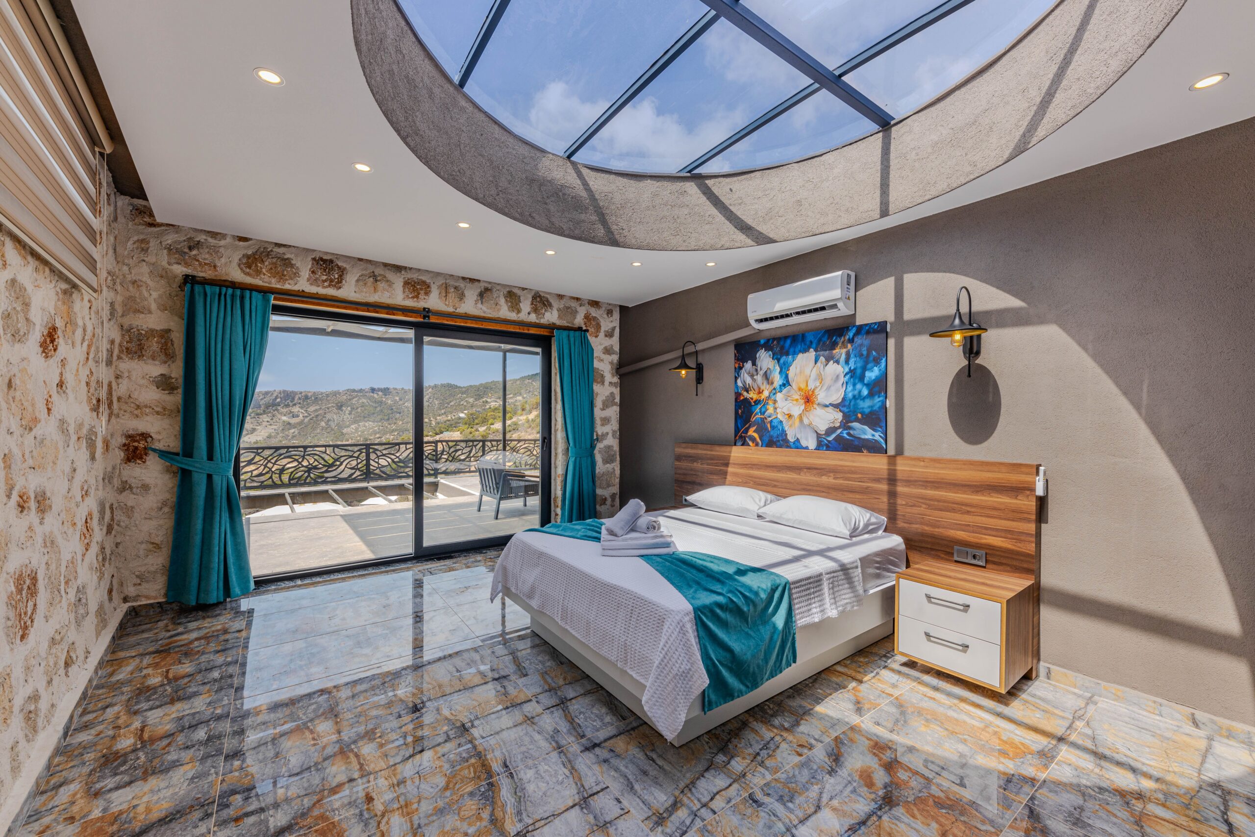 Contemporary bedroom design featuring bright skylight and scenic outdoor view.